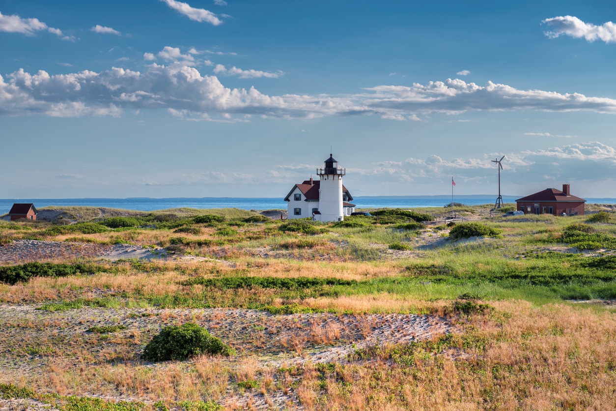 Race Point Light Lighthouse in sand dunes on the beach at Cape Cod, New England, Massachusetts, USA.
